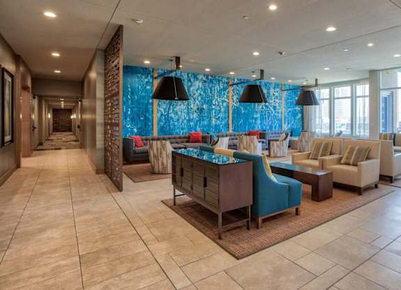 A large room with a blue backdrop and furniture.
