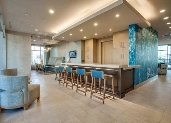 A bar area with a counter and stools.