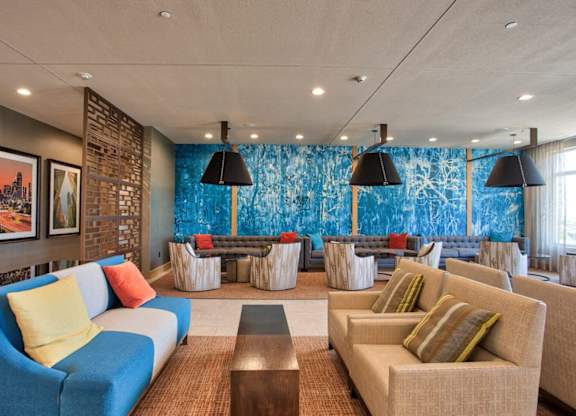 A living room with a blue couch and a brown coffee table.