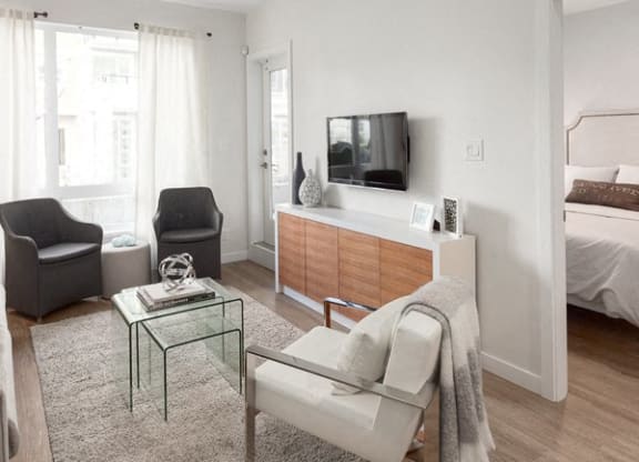 a living room with a couch and a table and a television