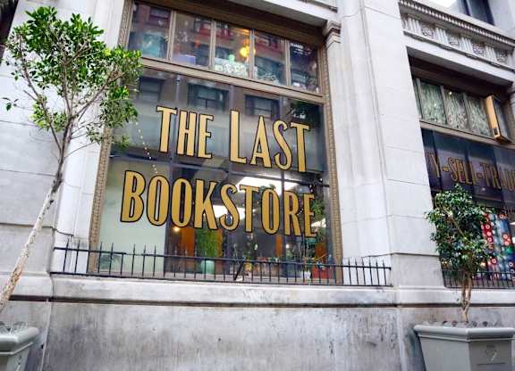 A tree is in front of a bookstore.