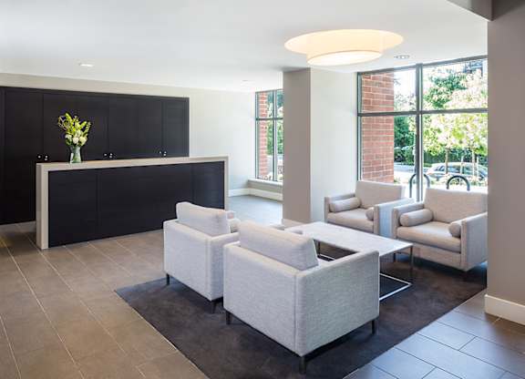 A black and white reception area with a flower vase on the counter.