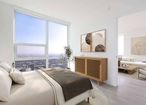 A bedroom with a large bed and a view of the city.
