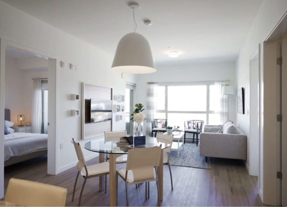 a dining room and living room in a small apartment