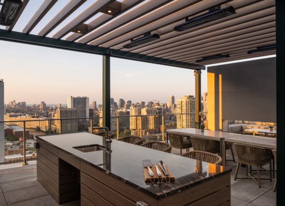 a terrace with a table and chairs and a view of a city