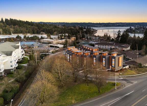 A road with a curve and a building on the side. at The Narrows at Clare Apartments , Washington, 98310