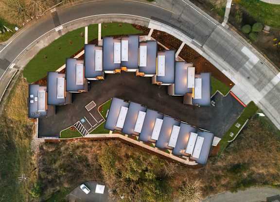 A large group of grey storage units are arranged in a circle. at The Narrows at Clare Apartments , Washington, 98310