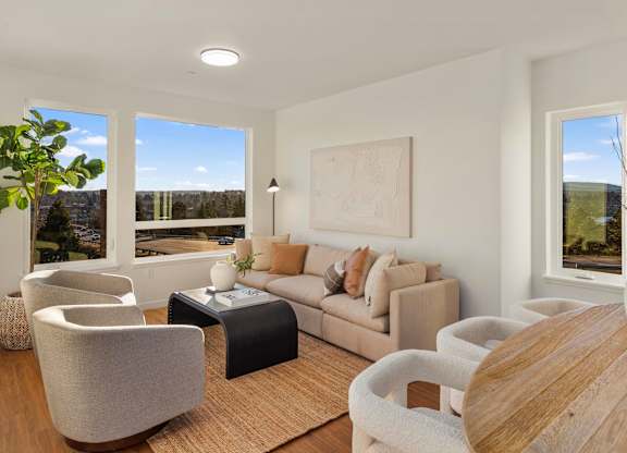 A living room with a couch, chairs, and a coffee table. at The Narrows at Clare Apartments , Washington, 98310