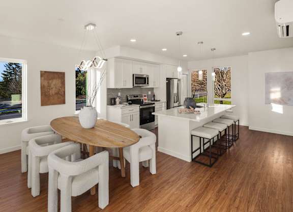 A modern kitchen with a dining table and chairs. at The Narrows at Clare Apartments , Bremerton, WA, 98310
