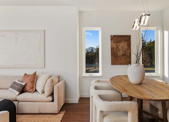 A living room with a couch, chairs, and a table. at The Narrows at Clare Apartments , Bremerton, 98310
