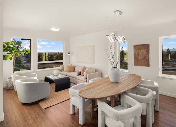 A modern living room with a large table and chairs. at The Narrows at Clare Apartments , Bremerton, 98310