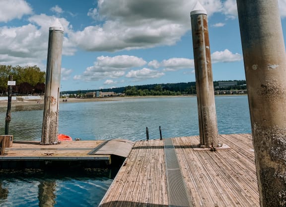 a wooden dock with three pillars on the side of it at Rivulet, Washington, 98383
