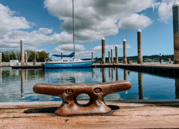 a dock with boats and clouds in the background at Rivulet, Silverdale, WA