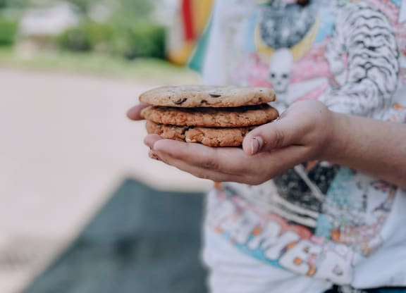 a boy in a colorful shirt holding a stack of cookies at Rivulet, Silverdale, Washington