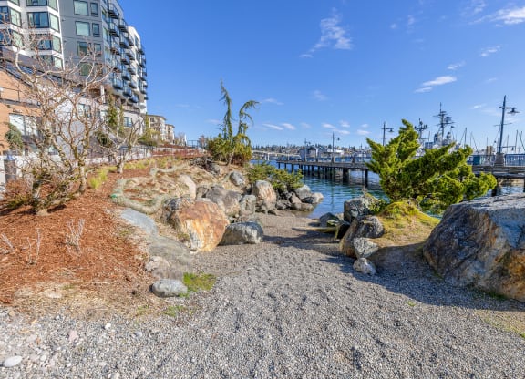 a path leading down to the water with a bridge in the background at Marina Square, Bremerton, 98337