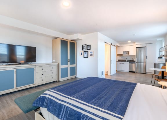 a bedroom with a bed and a tv in a room at Marina Square, Washington, 98337