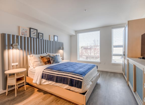 a bedroom with a bed and a desk with a chair at Marina Square, WA 98337