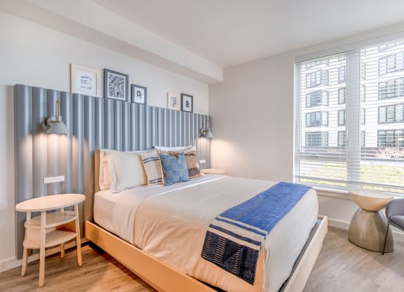 a bedroom with a bed and two windows at Marina Square, Bremerton, Washington 98337