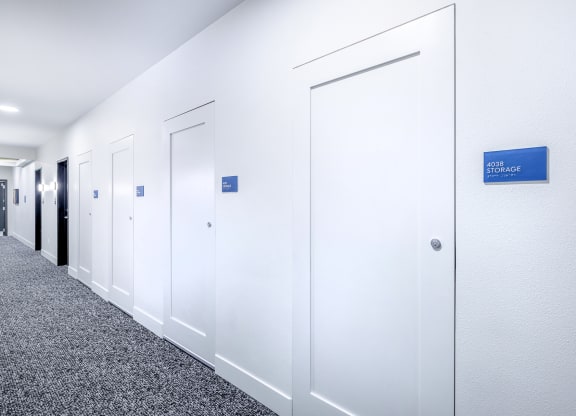 a row of white offices with a blue sign on the wall at Marina Square, WA 98337