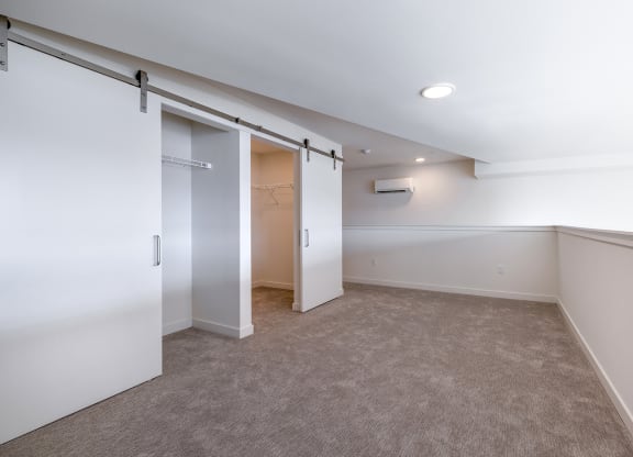 a bedroom with a closet and a carpeted floor at Marina Square, Washington, 98337