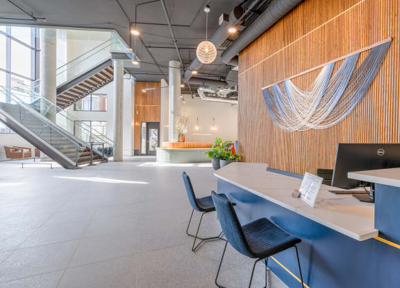 a large open space with a blue desk and blue chairs at Marina Square, WA 98337