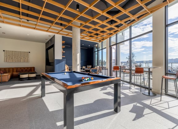 Game Lounge with a pool table, lounging couches, and floor to ceiling windows at Marina Square, WA 98337