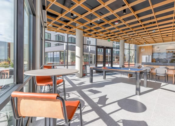a common area with tables and chairs and a ping pong table at Marina Square, Bremerton, 98337