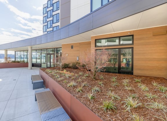 a courtyard with benches and plants next to a building at Marina Square, WA 98337