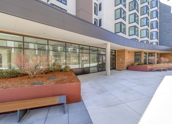 a courtyard with benches and a building in the background at Marina Square, Bremerton, WA