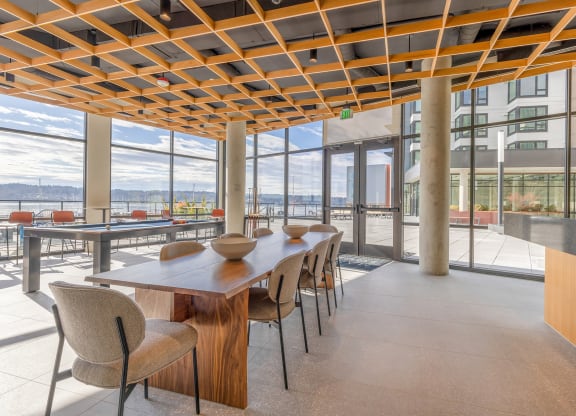 a dining area with a long wooden table and chairs at Marina Square, Washington, 98337