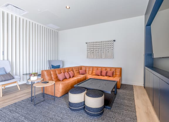 a living room with a brown leather couch and two blue chairs at Marina Square, Washington