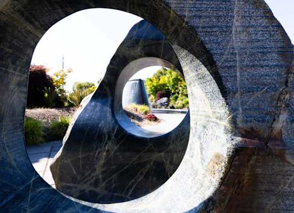 A person is walking through a circular stone structure.