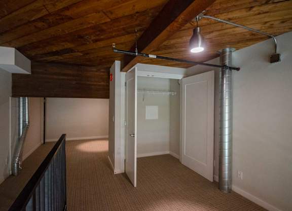 A room with a wooden ceiling and a white door at B Flats Apartments, Bremerton, WA