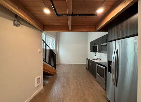 A kitchen with a refrigerator, oven, and microwave at B Flats Apartments, Bremerton, WA