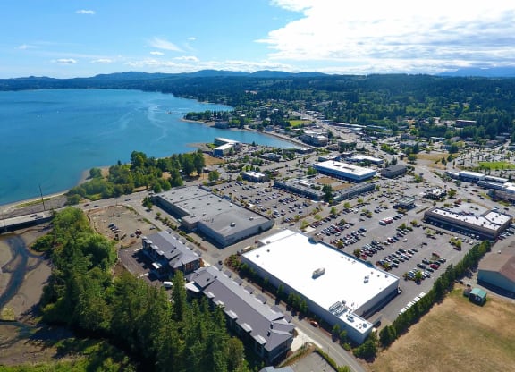 an aerial view of a parking lot with a lake in the background at Rivulet, Silverdale, Washington