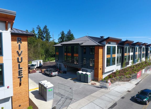 a row of buildings with a blue sky in the background at Rivulet, Silverdale, 98383