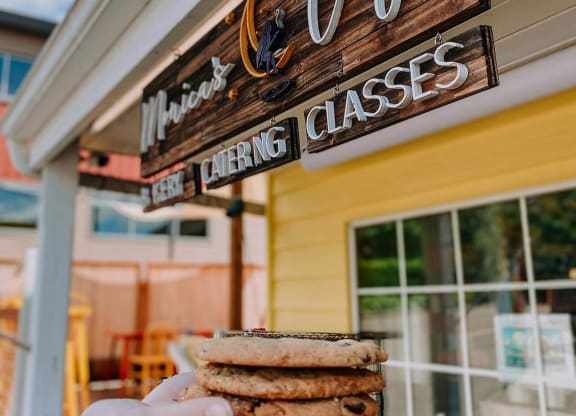 a hand holding a sandwich in front of a building at Rivulet, Silverdale, 98383