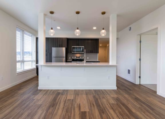 a kitchen and living room with a white counter top and at Rivulet, Silverdale, WA