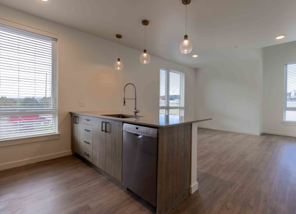 an empty kitchen with a large island in the middle at Rivulet, Silverdale Washington