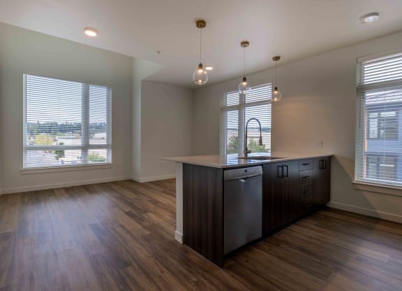 an empty kitchen with a large window and a counter top at Rivulet, Silverdale