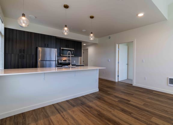 a kitchen with a large island and a stainless steel refrigerator at Rivulet, Silverdale, WA