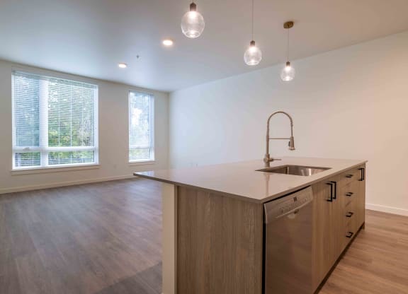 an empty kitchen with an island in the middle at Rivulet, Silverdale, 98383