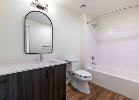 a bathroom with a toilet sink and a mirror at Rivulet, Silverdale Washington