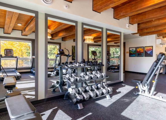 the gym is stocked with weights and cardio equipment at Rivulet, Silverdale, 98383