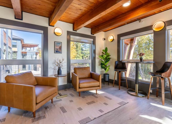 a living room with two chairs and a bar with windows at Rivulet, Washington