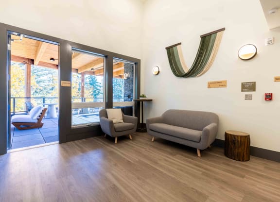 a living room with couches and chairs and a door to a balcony at Rivulet, Silverdale Washington