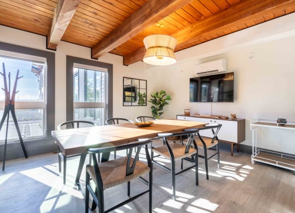 a dining room with a table and chairs      and a kitchen at Rivulet, Washington