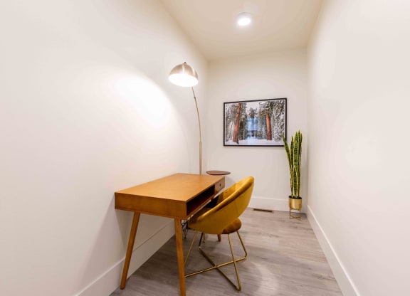 a home office with a wooden desk and yellow chairs at Rivulet, Washington, 98383