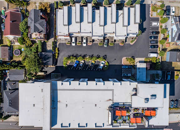 an aerial view of a parking lot with cars parked on top of a building at Spyglass Hill Apartments, Bremerton