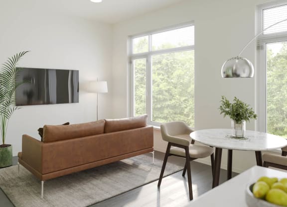 a living room with white walls and a brown couch at Rivulet, Silverdale, 98383